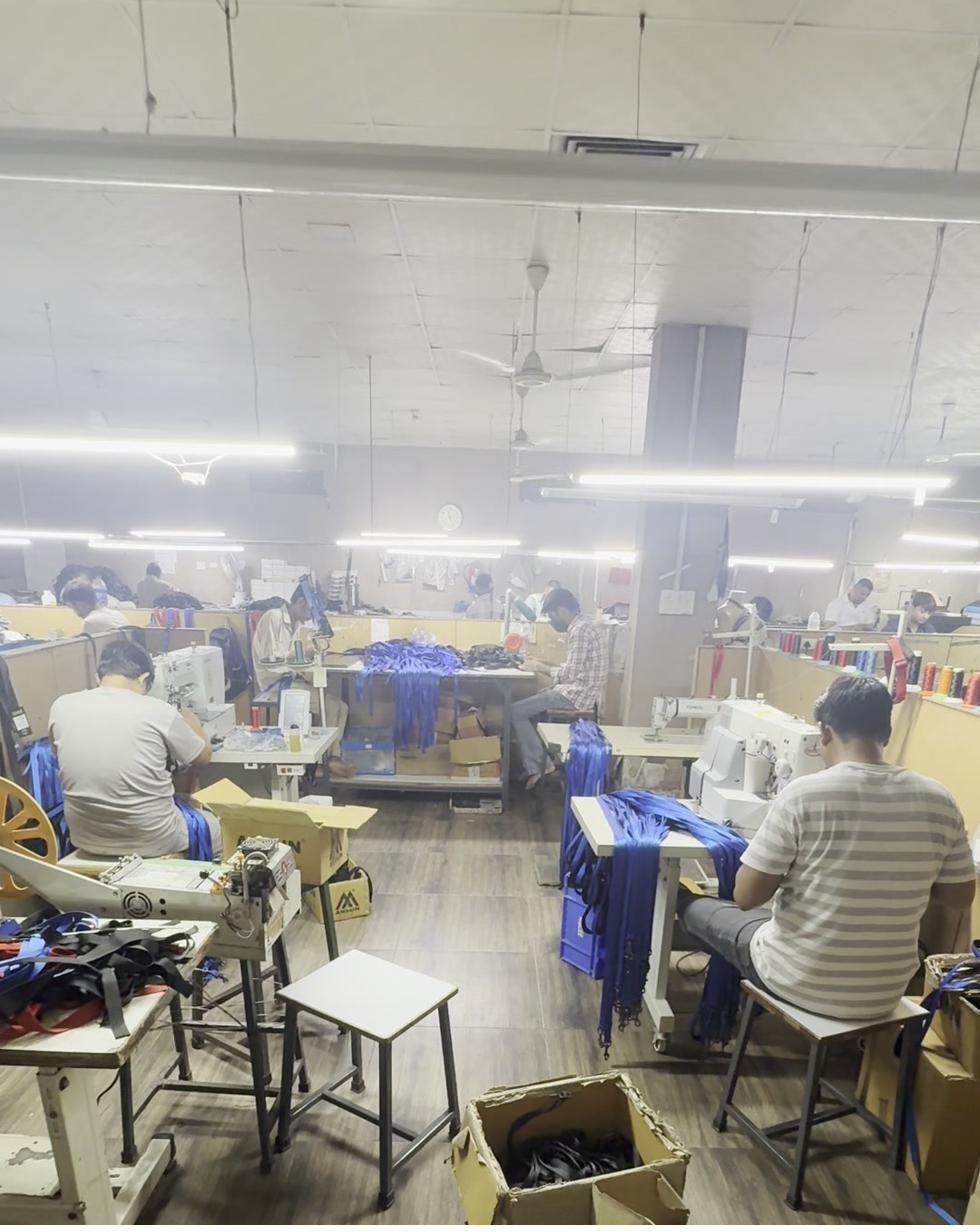 Assembly floor with workers building leather hardware and harnesses